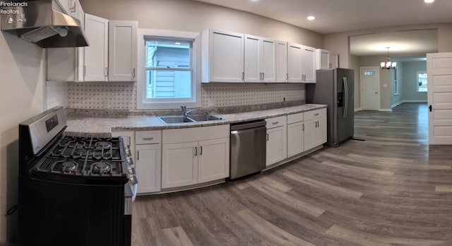 kitchen featuring white cabinets, appliances with stainless steel finishes, and tasteful backsplash