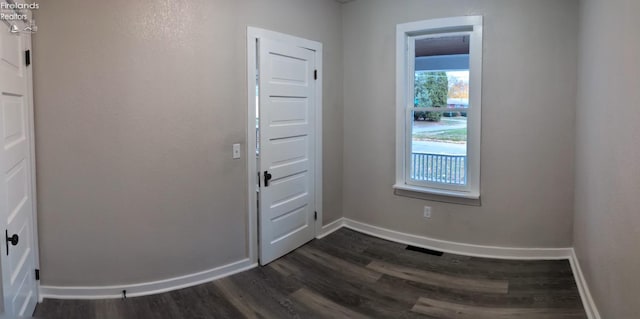 entryway with dark wood-type flooring