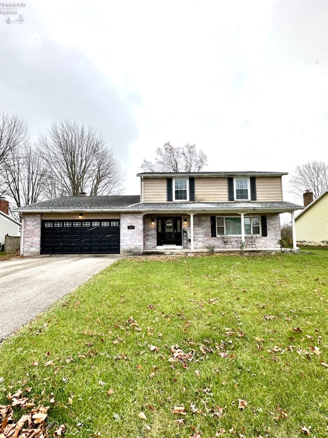 view of front property with a garage and a front yard