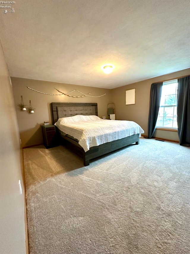 unfurnished bedroom with a textured ceiling and carpet floors