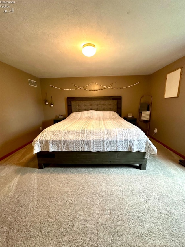 carpeted bedroom with a textured ceiling