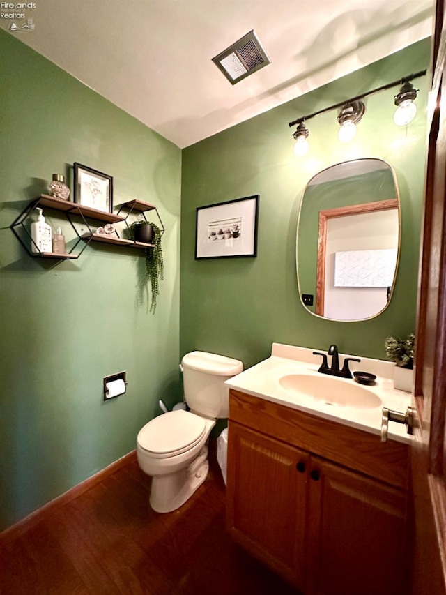 bathroom with vanity, hardwood / wood-style flooring, and toilet