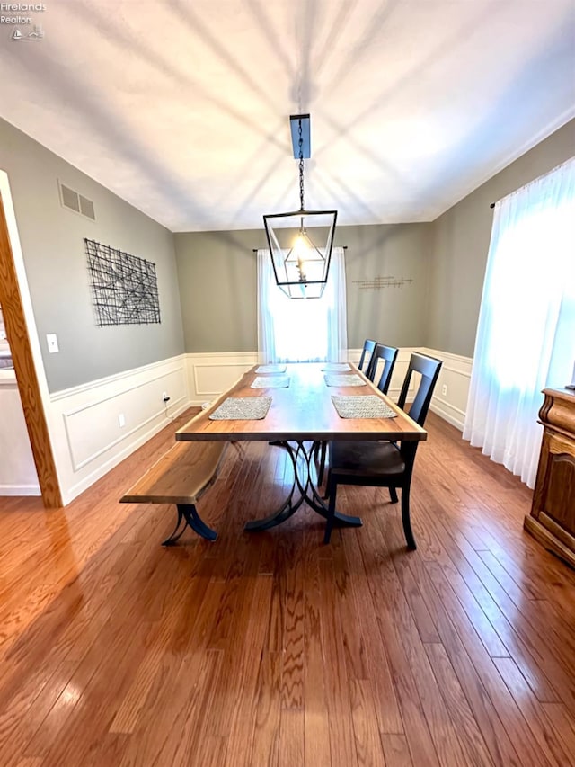 dining room featuring hardwood / wood-style flooring and an inviting chandelier