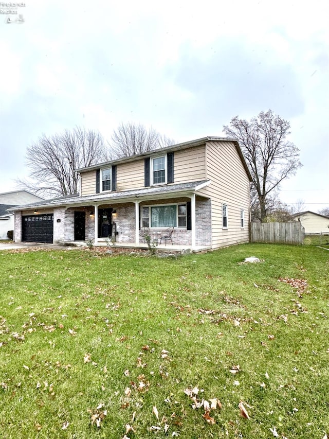 view of property with a front yard and a garage