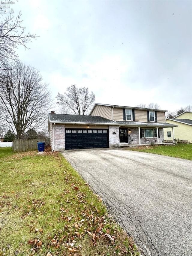 front facade featuring a garage and a front lawn