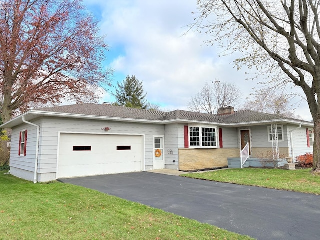 single story home with a front yard and a garage