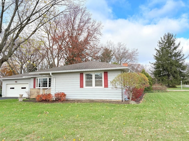 view of side of home featuring a garage and a yard