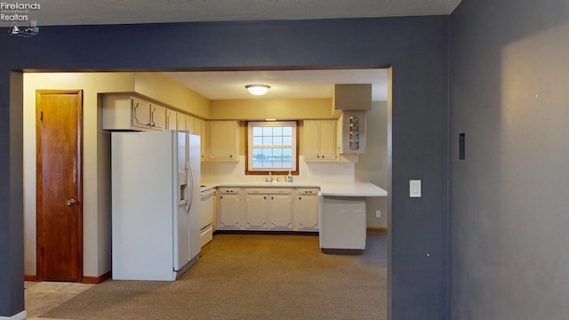 kitchen with light colored carpet and white appliances