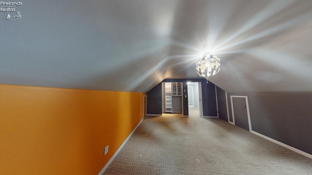 bonus room featuring carpet and vaulted ceiling