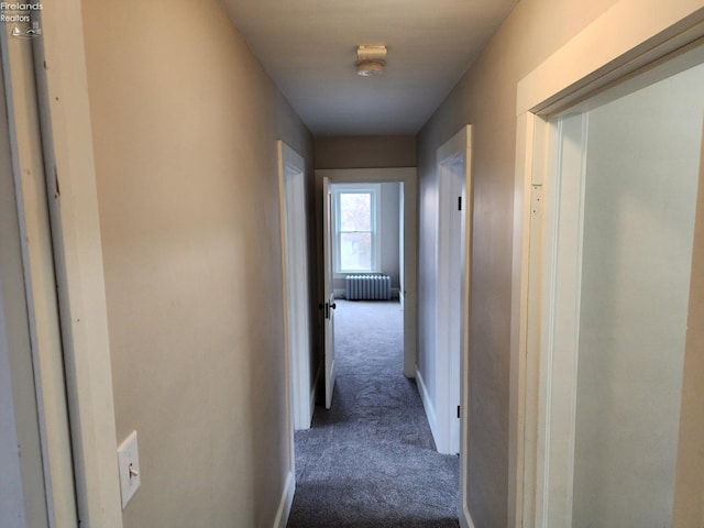 corridor featuring carpet and radiator