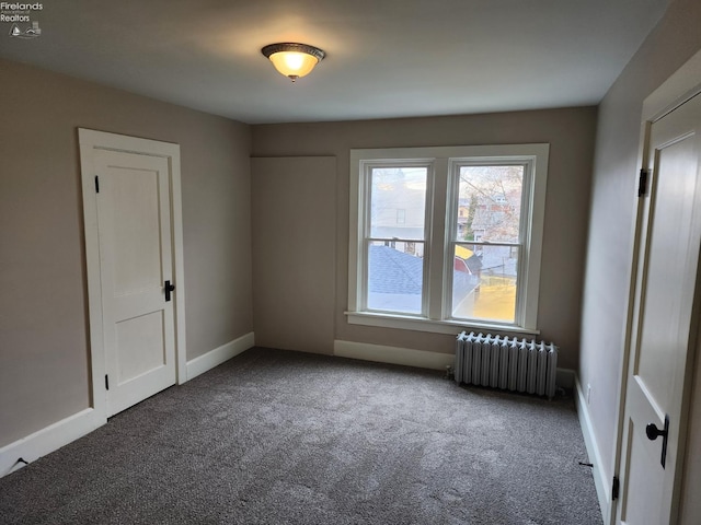 carpeted spare room with radiator