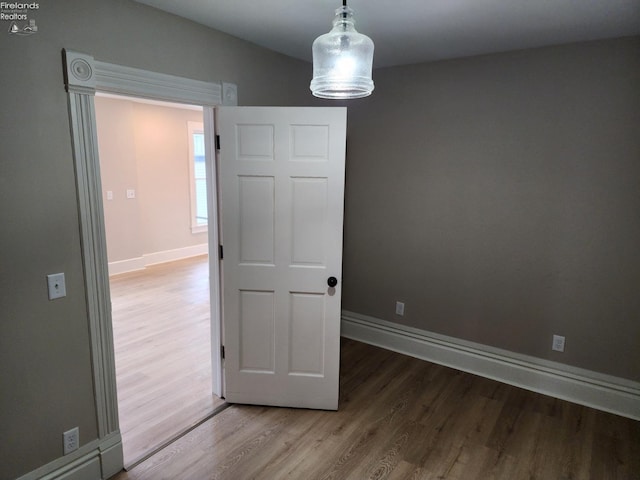 spare room with hardwood / wood-style floors