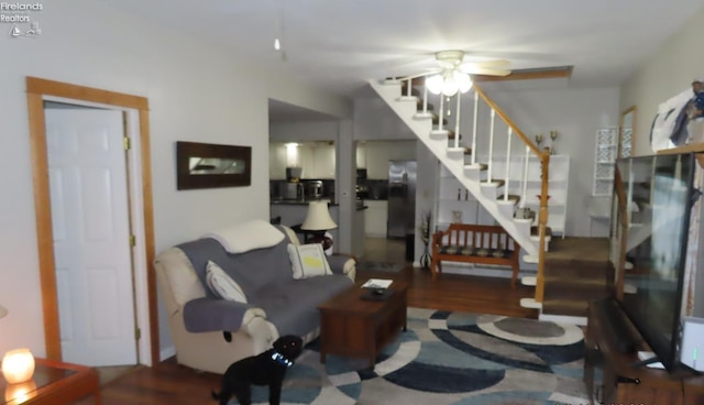 living room with dark hardwood / wood-style floors and ceiling fan