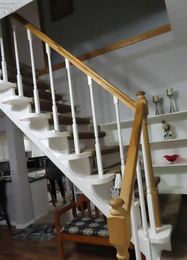 stairs with hardwood / wood-style floors