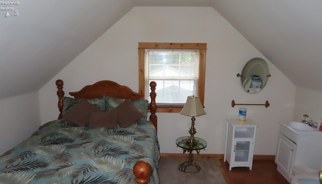 bedroom with sink and lofted ceiling