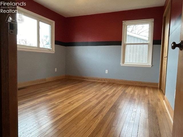 unfurnished room featuring light hardwood / wood-style floors