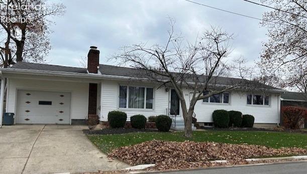 ranch-style house with a front lawn and a garage