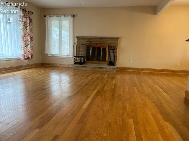 unfurnished living room with hardwood / wood-style flooring