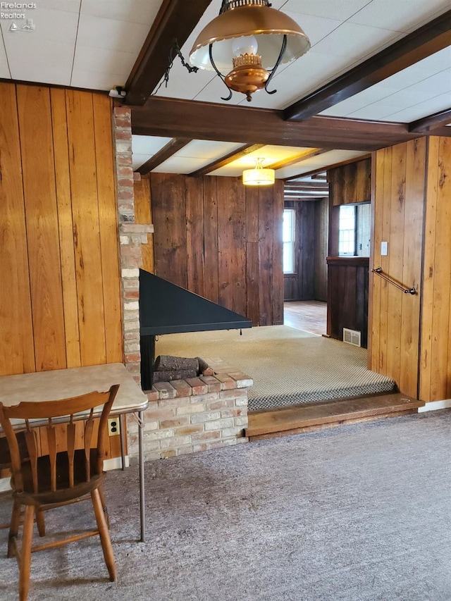 interior space with carpet flooring and wood walls