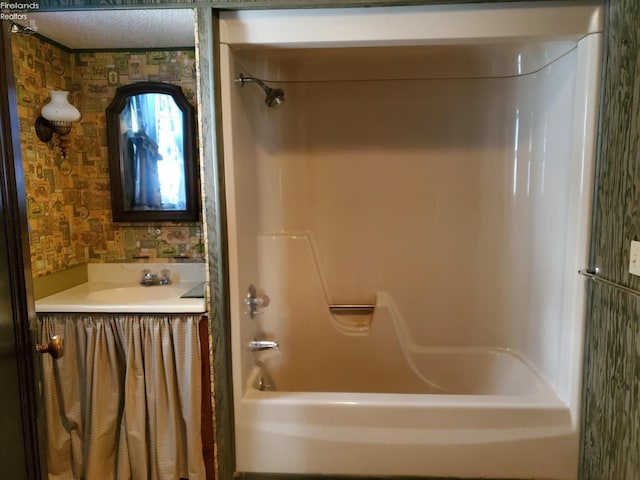 bathroom featuring tub / shower combination and sink