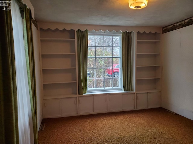 unfurnished room featuring carpet