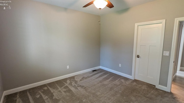 spare room with carpet flooring and ceiling fan