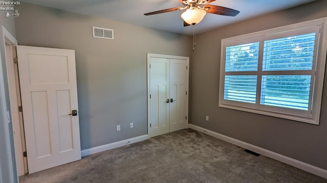 unfurnished bedroom featuring ceiling fan, carpet floors, and a closet