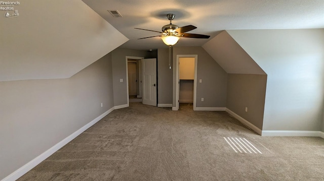 bonus room with light carpet, ceiling fan, and vaulted ceiling