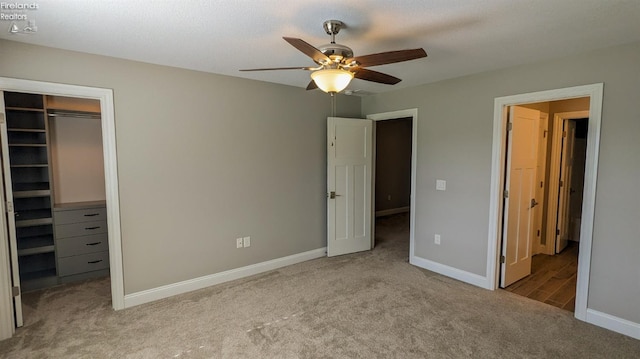 unfurnished bedroom with ceiling fan, carpet floors, and a closet