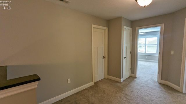 corridor with light colored carpet