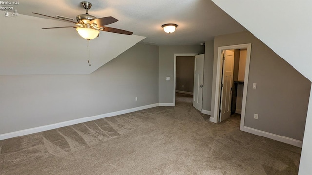 additional living space with carpet, ceiling fan, and lofted ceiling