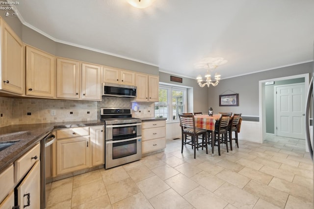 kitchen with pendant lighting, ornamental molding, stainless steel appliances, and a chandelier