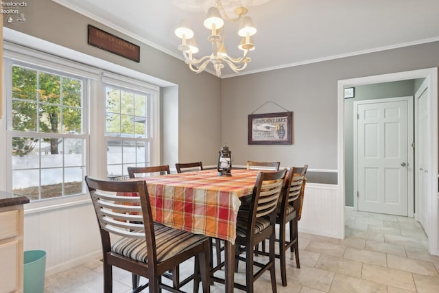 dining space featuring a notable chandelier and crown molding