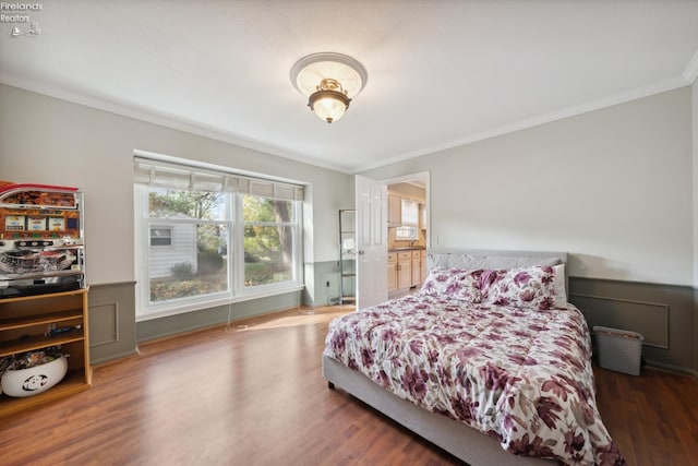 bedroom with dark hardwood / wood-style flooring and crown molding