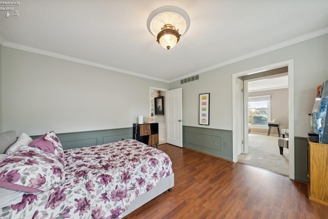 bedroom with ornamental molding and dark wood-type flooring