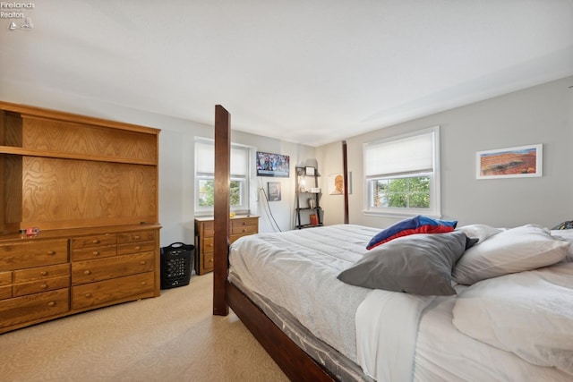 bedroom featuring light carpet