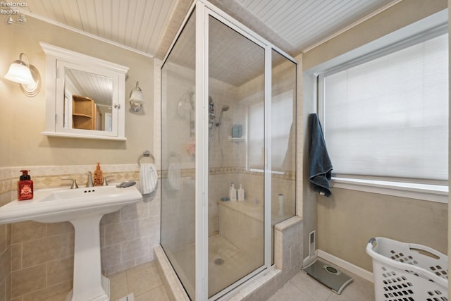 bathroom with an enclosed shower, ornamental molding, sink, wooden ceiling, and tile patterned flooring