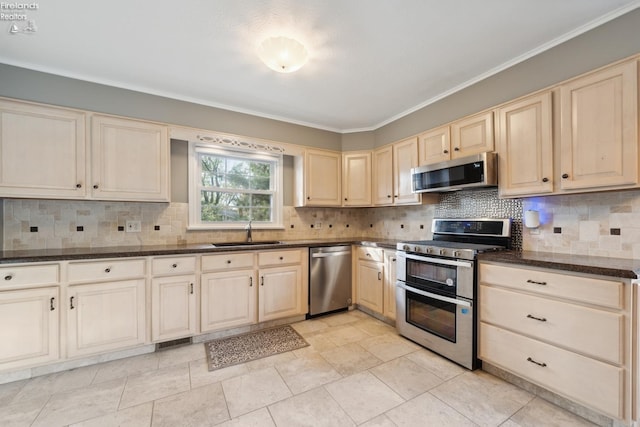 kitchen with sink, dark stone countertops, ornamental molding, tasteful backsplash, and stainless steel appliances