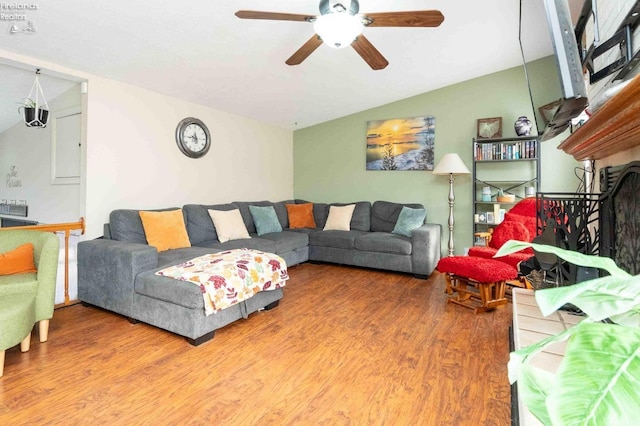 living room with wood-type flooring, ceiling fan, and lofted ceiling