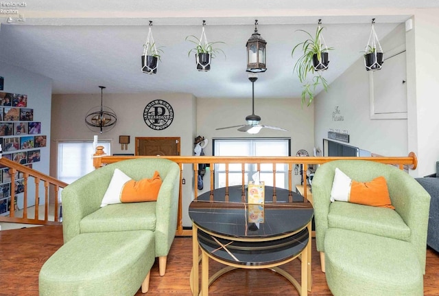 living area with hardwood / wood-style flooring and ceiling fan