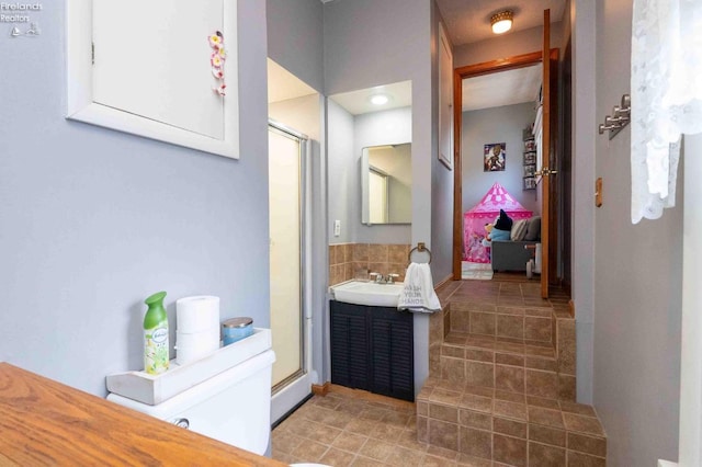 bathroom featuring tile patterned flooring, vanity, and a shower with door