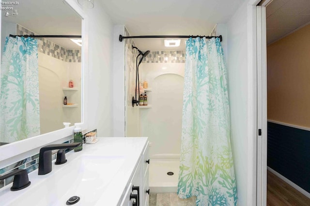 bathroom featuring vanity, hardwood / wood-style flooring, and walk in shower