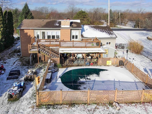 snow covered property with a wooden deck