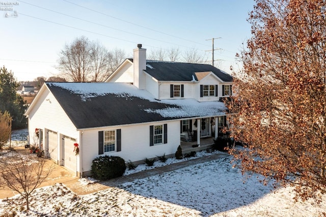 view of front of property with covered porch and a garage