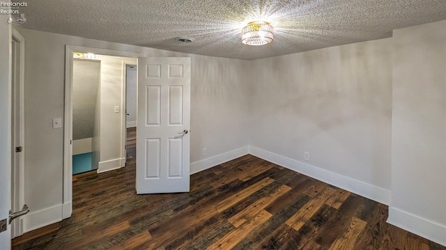 interior space featuring dark wood-type flooring and a textured ceiling