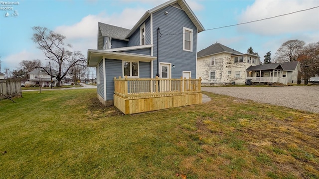 back of house with a yard and a wooden deck