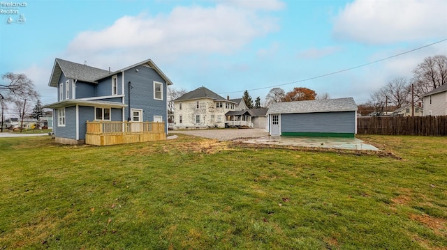 back of property featuring a wooden deck and a yard