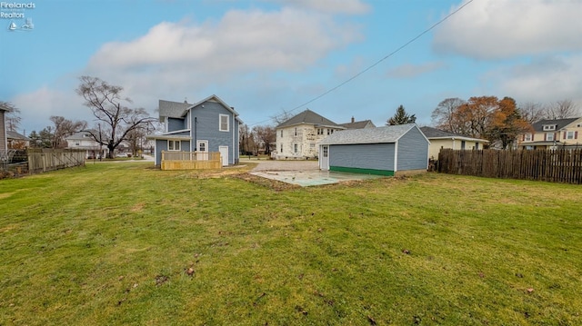 rear view of house featuring a lawn and a patio area