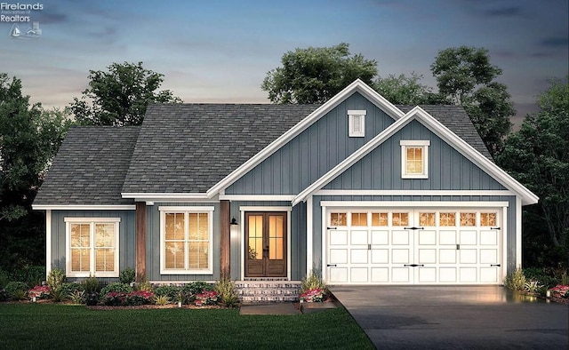 view of front of home with a yard and a garage