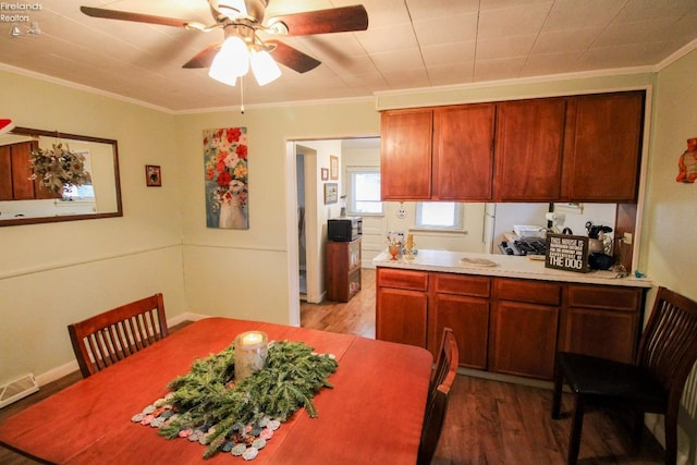 kitchen with hardwood / wood-style floors, ceiling fan, and ornamental molding